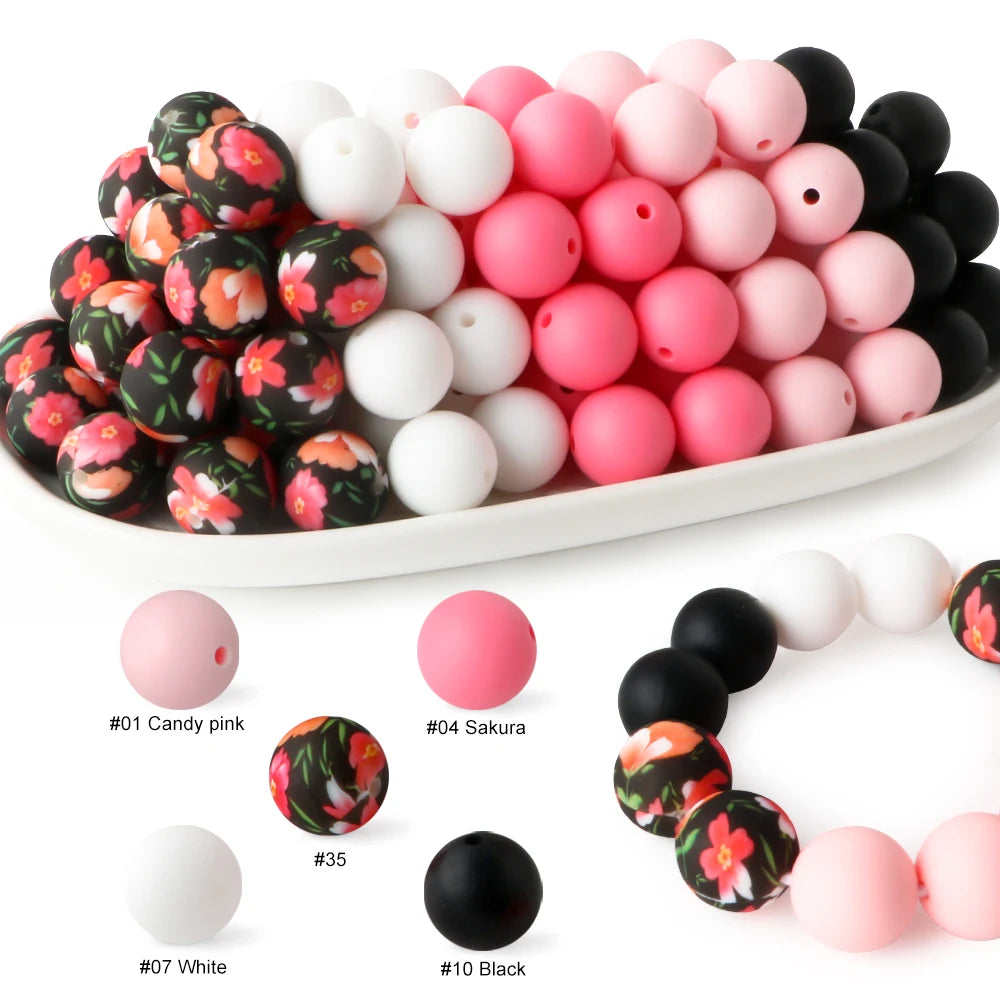 A collection of pink, white, and black silicone beads for DIY jewelry and crafts.