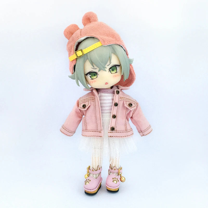 A 1/12 scale doll wearing a pink denim jacket and matching hat with light green hair.