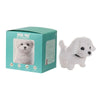 A white plush robot puppy toy with walking and barking features displayed in its packaging box.