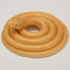 A realistic yellow rubber snake toy coiled on a white background.