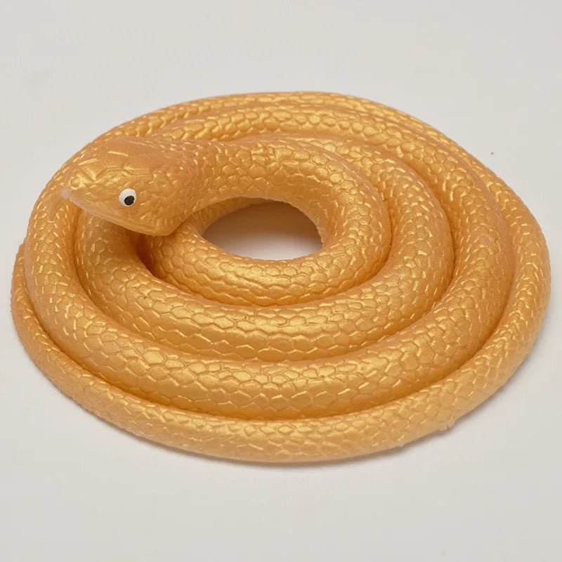 A realistic yellow rubber snake toy coiled on a white background.