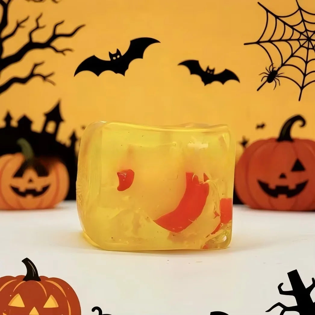 A yellow squishy ice cube toy set featuring Halloween themed ghost dumplings and bats against a yellow background.