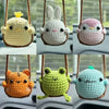 A collection of handmade crochet animal swing ornaments including a yellow duck, a white rabbit, a pink bird, an orange tiger
