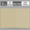 A sheet of round self-adhesive dot labels in a light yellow color, showing the grid pattern.