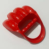 A bright red dinosaur claw sand digging toy for kids, shown from above.