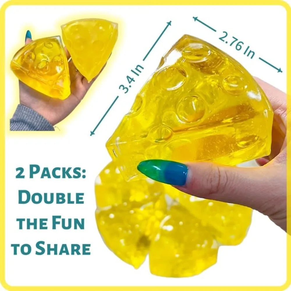 A hand holds a bright yellow honey cheese squishy stress ball, showing its texture and size relative to a finger.