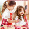 Two young girls play with a pink beauty salon kit including scissors, combs, and styling tools.