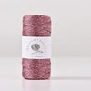 A skein of metallic pink glitter yarn for knitting and crochet