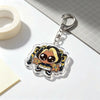An acrylic keychain charm featuring an anime-inspired character with dark hair and yellow accents, attached to a silver keyri