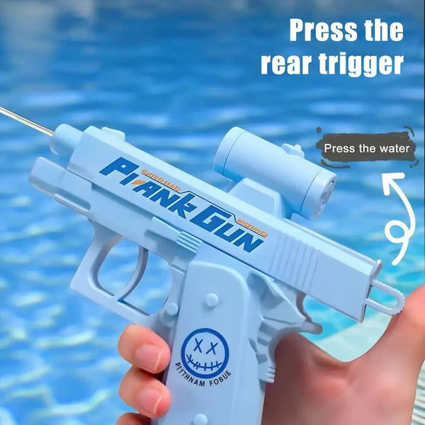 A hand holds a light blue water gun, ready to be pressed, with text instructing to press the rear trigger.
