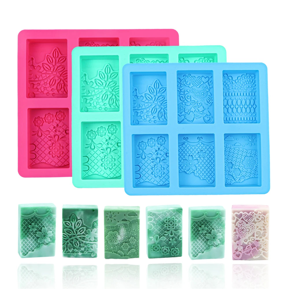 A pink silicone soap mold with six cavities featuring intricate lace patterns, alongside several finished green and purple so