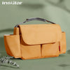 A tan leather bottle and cup holder designed for strollers, shown in a studio setting.