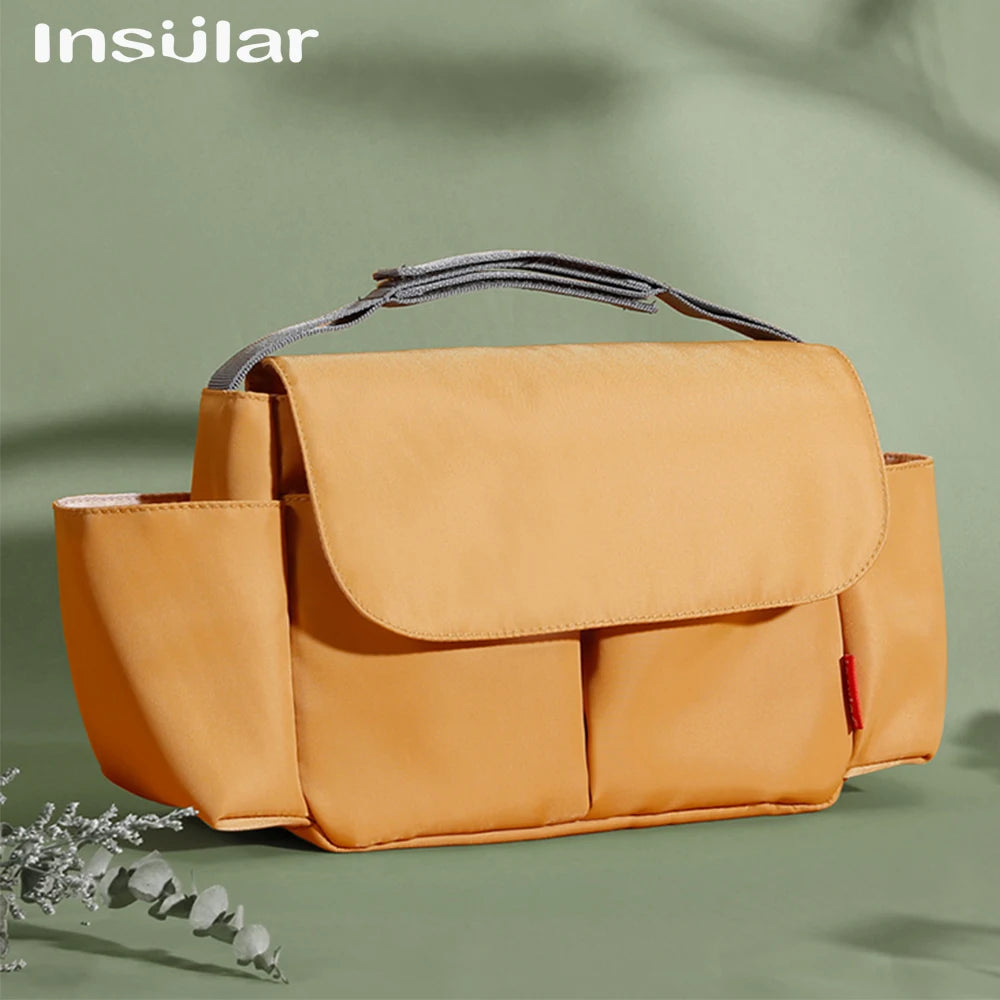 A tan leather bottle and cup holder designed for strollers, shown in a studio setting.