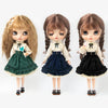 Three dolls with long hair wearing vintage lace maid dress sets in various colors
