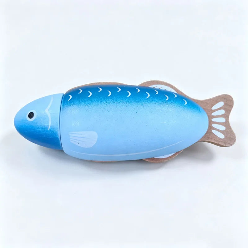 A blue wooden magnetic toy shaped like a fish, used as a cutting tool.