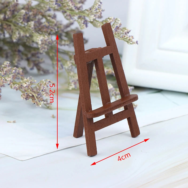 A small, brown wooden artist easel with measurements shown on a white surface.