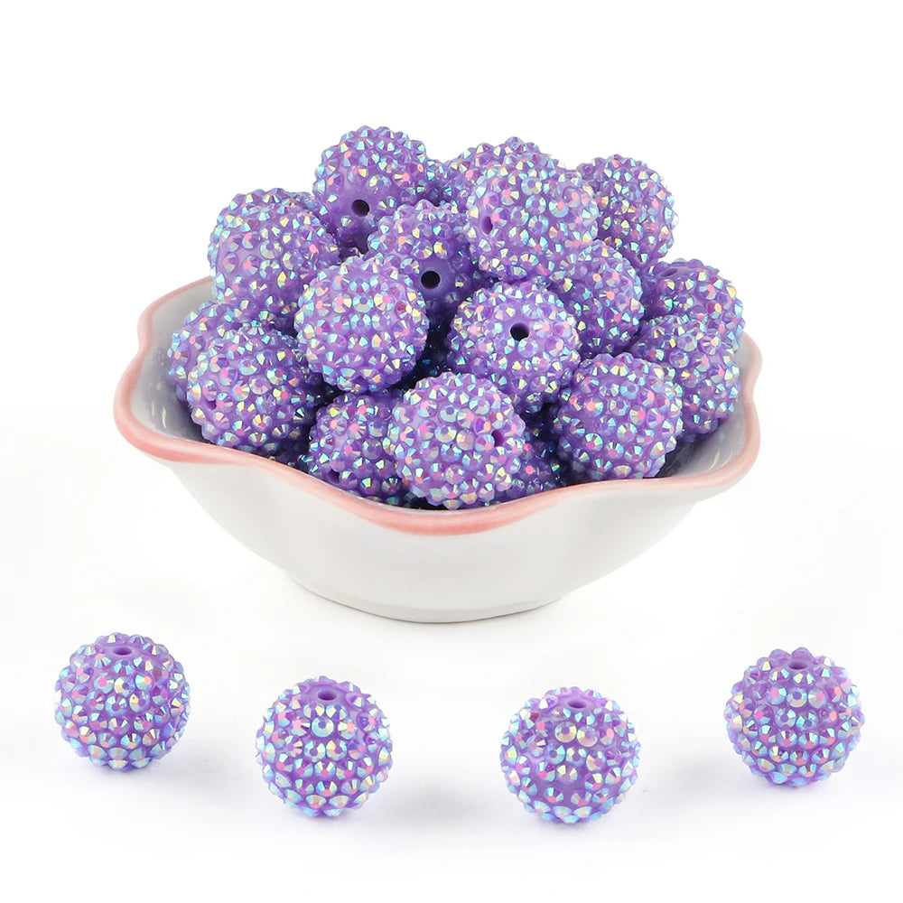 A pile of purple rhinestone acrylic beads for jewelry making