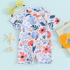 A baby rash guard swimsuit featuring a floral pattern in shades of blue, pink, and orange.