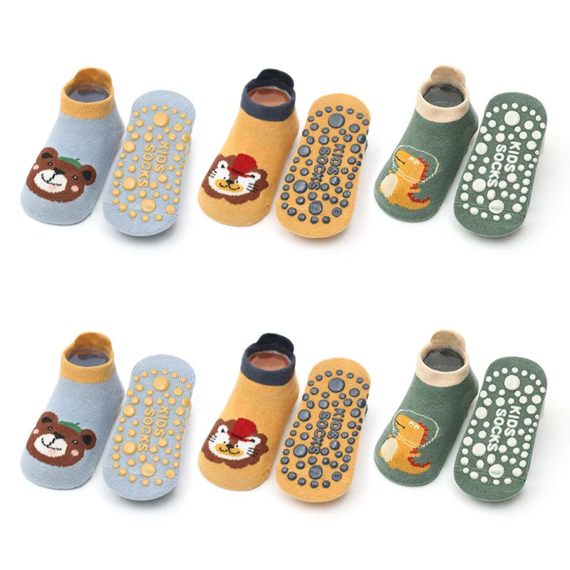 A set of six kids cotton cartoon animal socks with non-slip grips in various colors and designs.