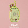A green pendant keychain featuring a character from the LABUBU series, used as a master hairstylist item.