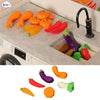 A set of miniature dollhouse vegetables including pumpkins, peppers, and squash in various colors