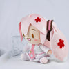 A pink Hatsune Miku plush doll with long hair and a pink outfit, sitting on a white surface.