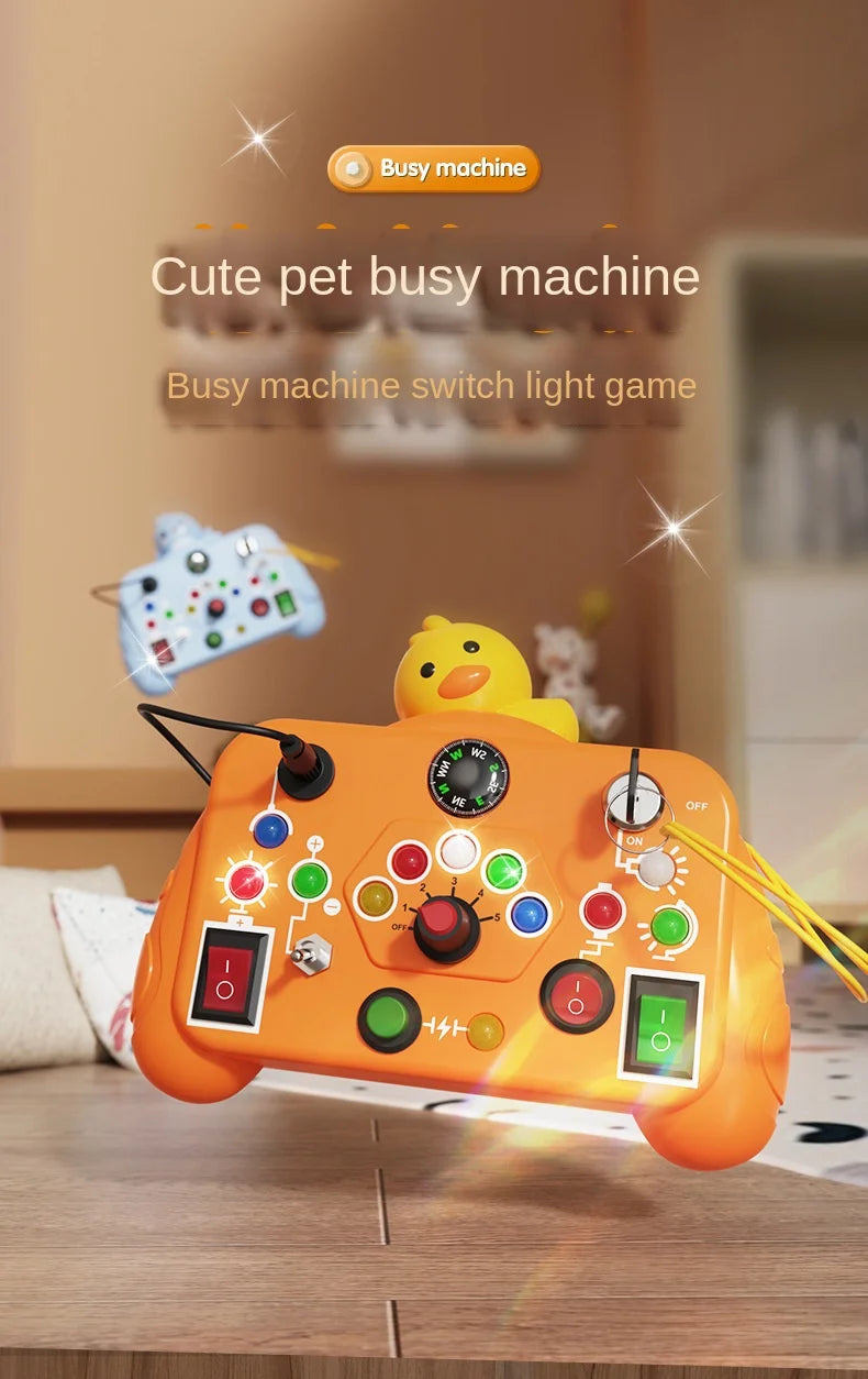 An orange busy machine toy with various switches and lights is shown on a wooden table.