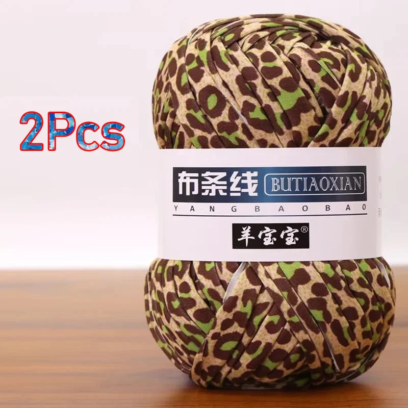 A ball of brown and green leopard print soft chunky yarn, sold as a 2-pack.