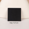 A black square jewelry display card is shown against a light background.