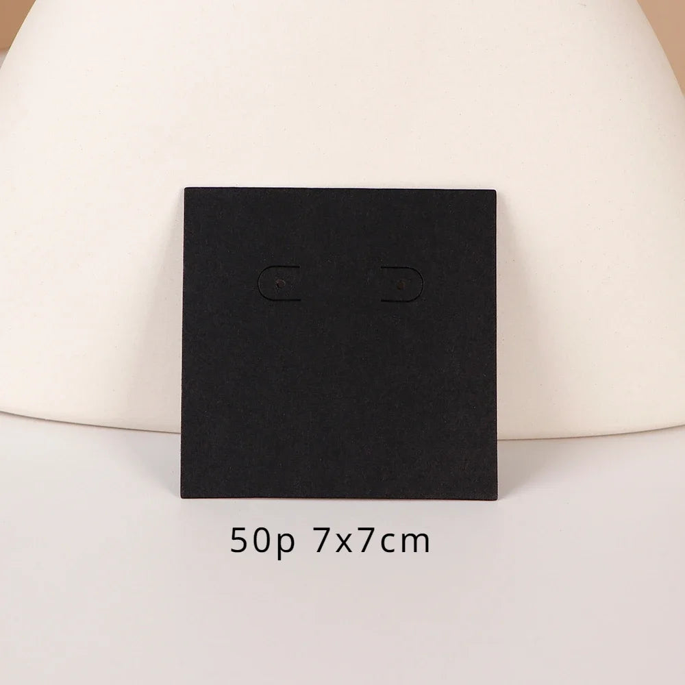 A black square jewelry display card is shown against a light background.