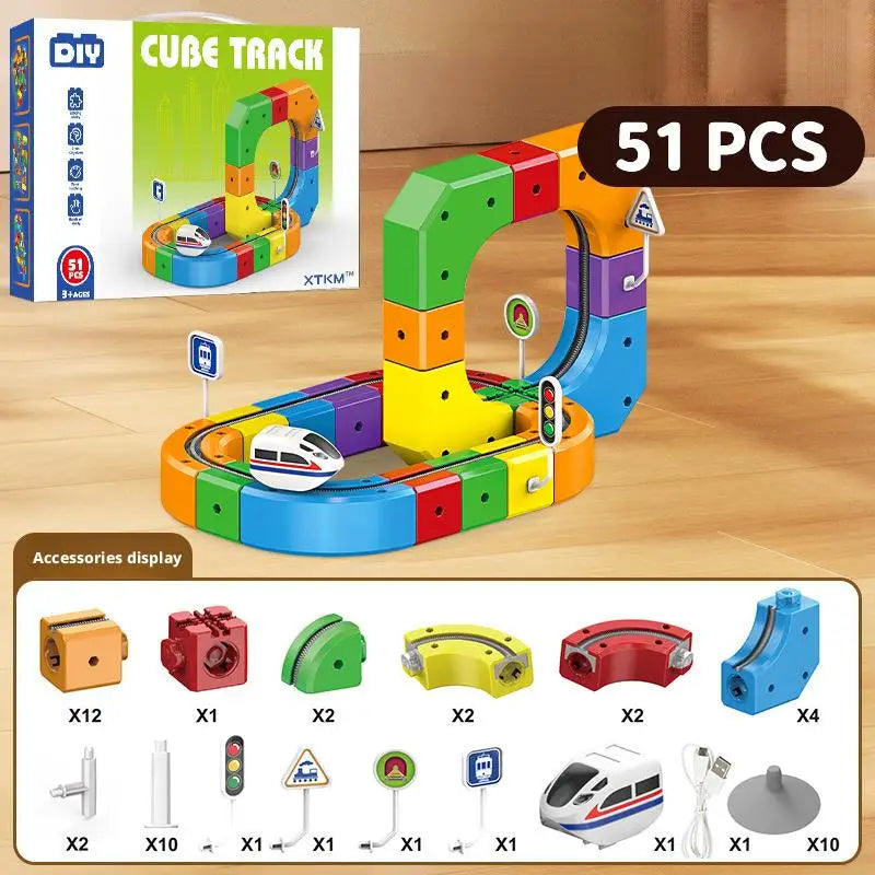 A set of 51 magnetic cube track building pieces and a USB rechargeable train model displayed on a wooden surface.