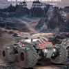 A black and red 1:18 scale 4WD off-road RC monster truck is shown on a rugged, rocky terrain.