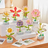 A collection of colorful rose flower building blocks in various shades of pink, yellow, and purple arranged on a wooden surfa