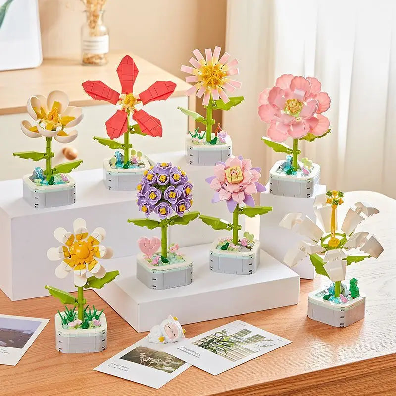 A collection of colorful rose flower building blocks in various shades of pink, yellow, and purple arranged on a wooden surfa