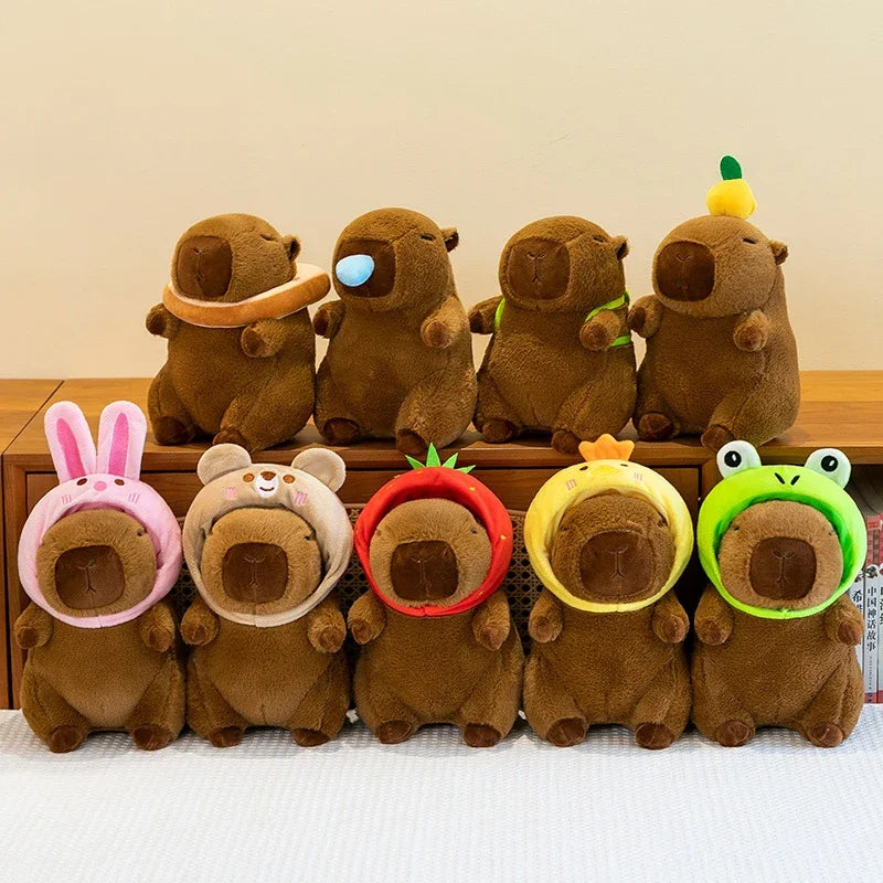 A row of adorable capybara plush toys in various colors and expressions.