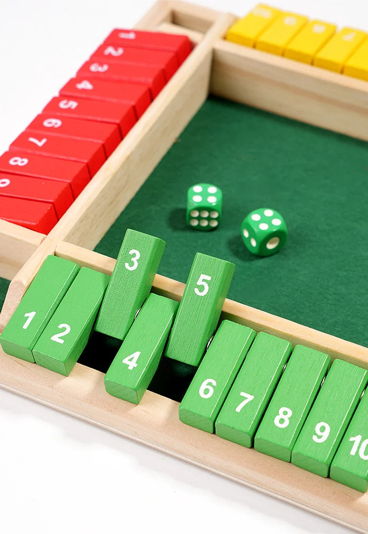 A wooden dice game set featuring red and green numbered blocks and dice on a green board.
