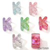 A collection of colorful acrylic letter beads in various shades of purple, pink, and green.