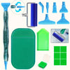 A complete diamond painting tool kit showing various tools and a green plastic mat.