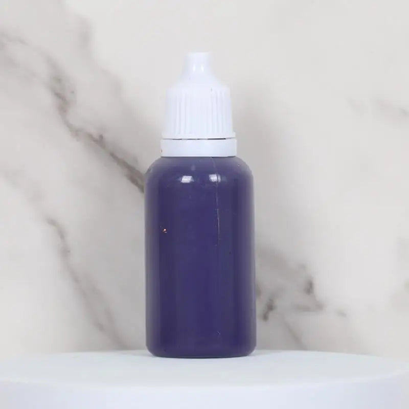 A purple bottle of water marbling paint art kit for kids sitting on a white surface.