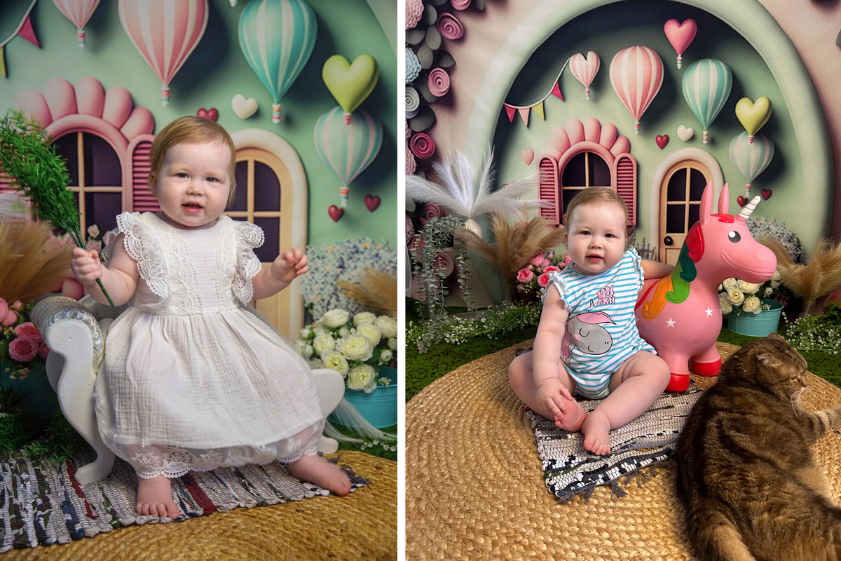 A baby girl dressed in a white dress posing in an underwater castle mermaid theme party backdrop with pink balloons and green