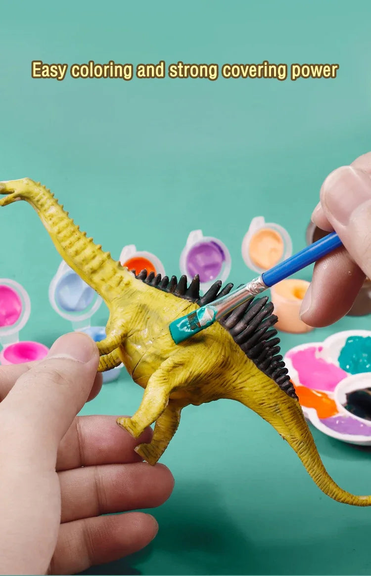 A hand holds a yellow dinosaur model being painted with various colored paints.