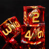 A set of red resin dice featuring golden elven numbers, including a 2 and a 4.
