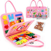 A pink Montessori busy board for toddlers featuring various colorful manipulative items and a handle.