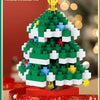 A green Christmas tree built from white and blue micro building blocks with a gold topper.