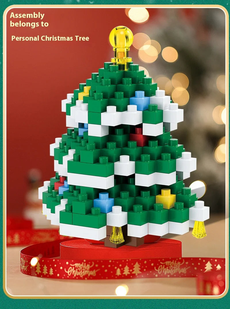 A green Christmas tree built from white and blue micro building blocks with a gold topper.