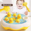 A toddler is playing with a yellow hammer toy shaped like an animal on a circular board.