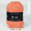 A ball of soft orange milk cotton yarn labeled YIMIAN 03 for knitting and crochet