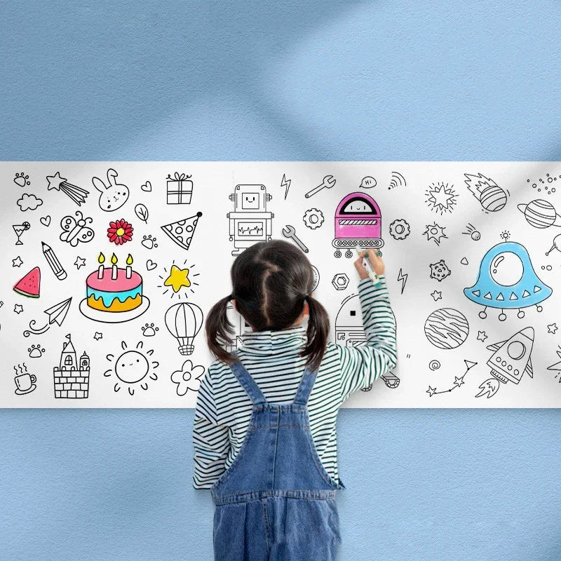 A child is drawing on a large sheet of white paper with various doodles and icons.