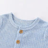 Light blue striped cotton baby bodysuit with a rounded neckline and wooden buttons