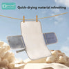 A white portable waterproof baby changing mat with blue accents is shown hanging outdoors against a cloudy sky.